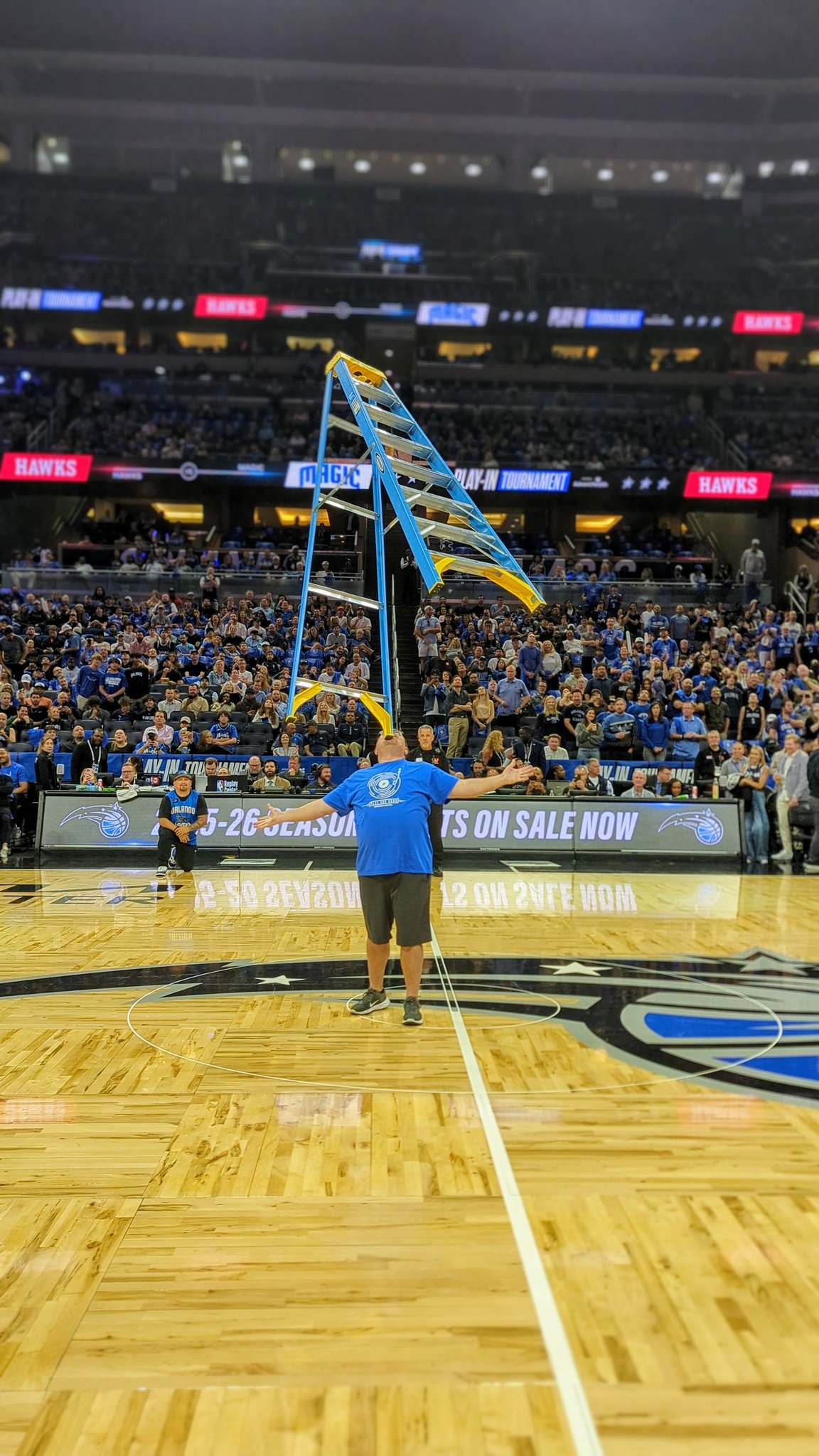 Kevin Shiflett The Amazing Chin Balancer performing decorated ladder balance at NBA arena