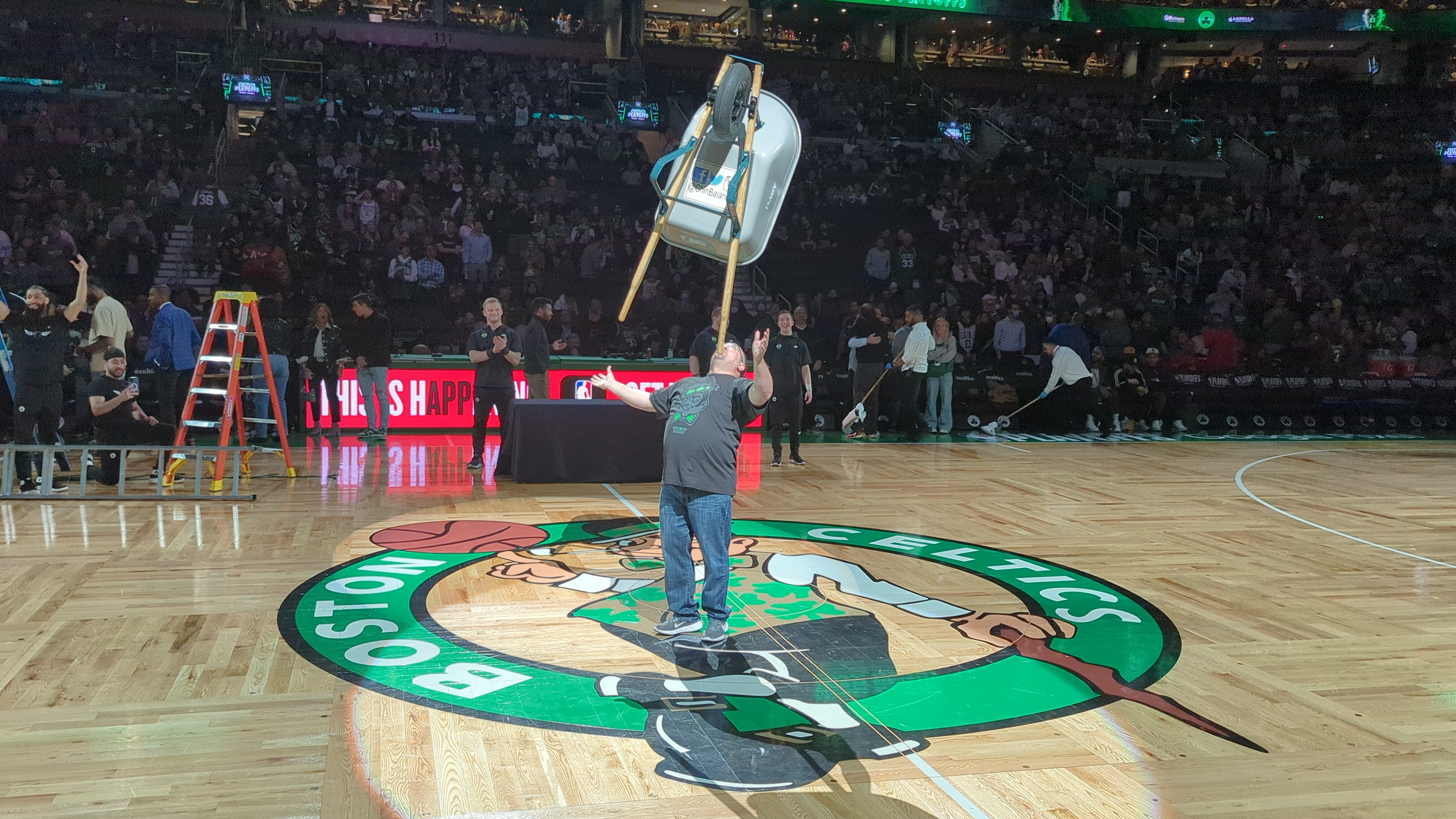 Kevin Shiflett balancing a chair on his chin at Boston Celtics NBA game halftime show